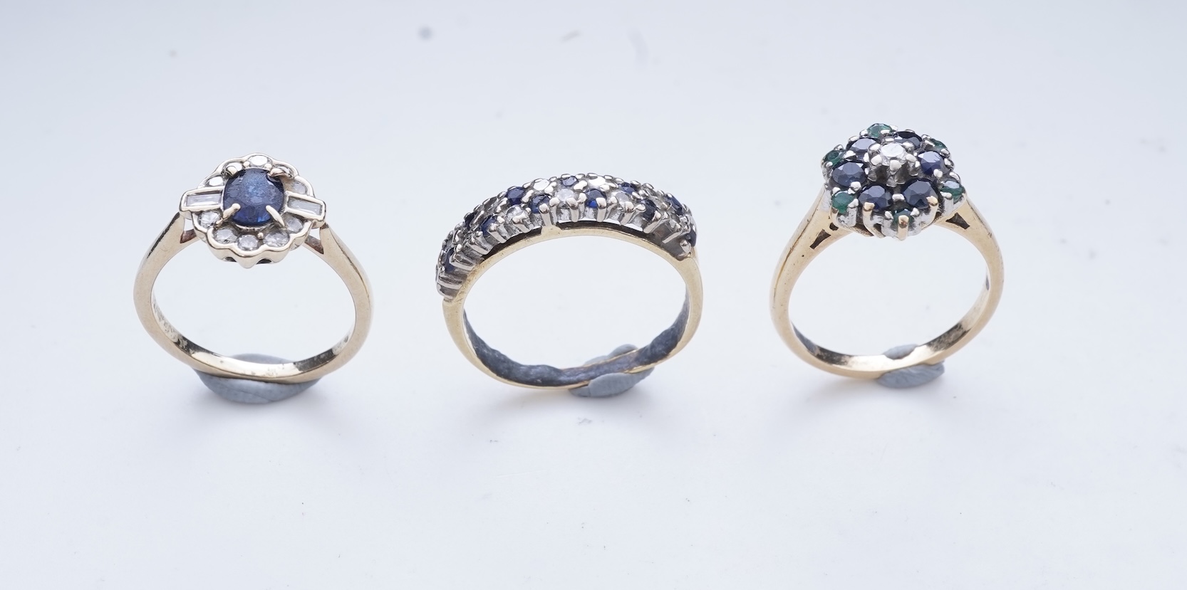 A collection of three sapphire and diamond rings
